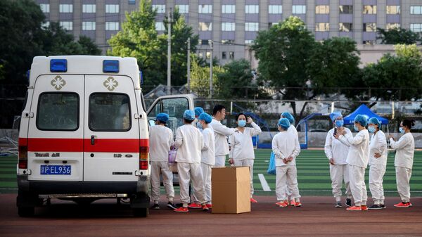 Медицинские работники в спортивном центре Guangan, где проходит тестирование людей на коронавирус, живущих рядом или посещающих рынок Синьфади Медицинские работники в спортивном центре Guangan, где проходит тестирование людей на коронавирус, живущих рядом или посещающих рынок Синьфади