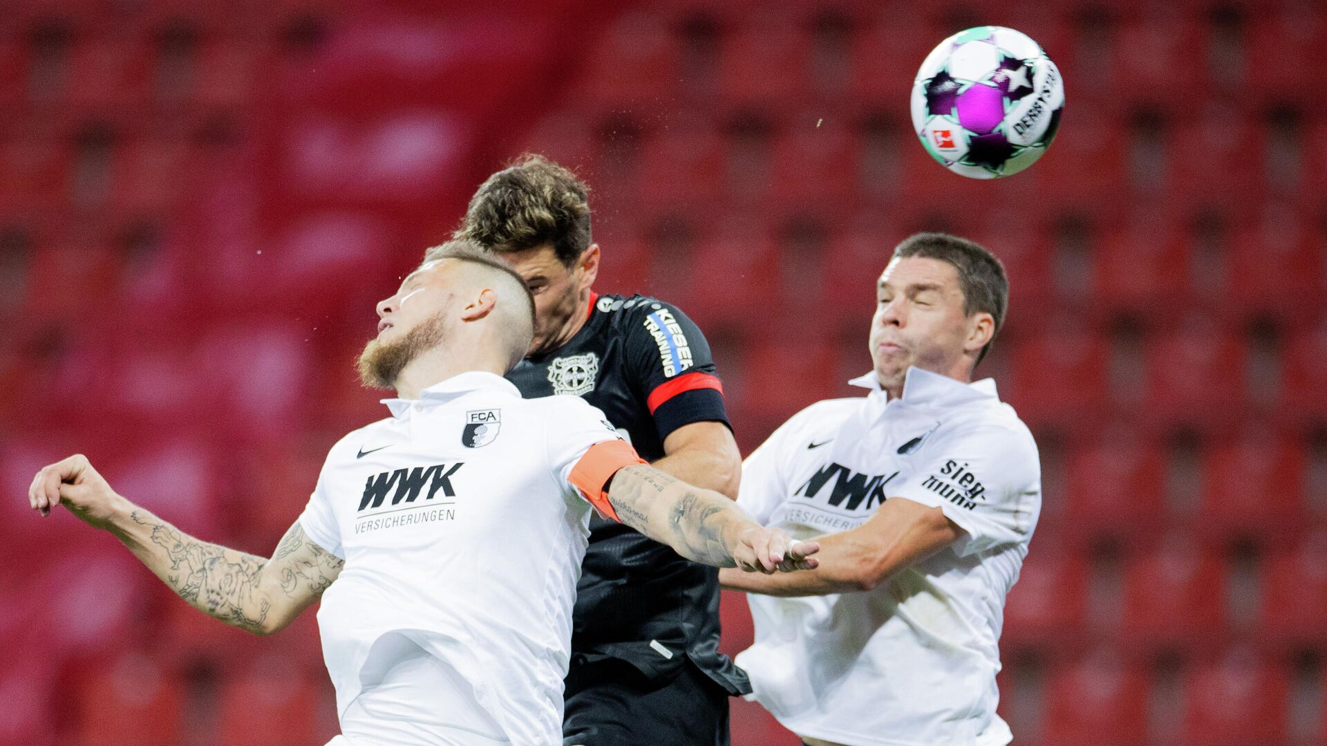 Leverkusen's Italian forward Lucas Alario (M), Augsburg's Dutch defender Jeffrey Gouweleeuw (L) and Augsburg's German defender Raphael Framberger vie for the ball during the German first division Bundesliga football match Bayer 04 Leverkusen v FC Augsburg, in Leverkusen, western Germany, on October 26, 2020. (Photo by Rolf Vennenbernd / POOL / AFP) / DFL REGULATIONS PROHIBIT ANY USE OF PHOTOGRAPHS AS IMAGE SEQUENCES AND/OR QUASI-VIDEO Leverkusen's Italian forward Lucas Alario (M), Augsburg's Dutch defender Jeffrey Gouweleeuw (L) and Augsburg's German defender Raphael Framberger vie for the ball during the German first division Bundesliga football match Bayer 04 Leverkusen v FC Augsburg, in Leverkusen, western Germany, on October 26, 2020. (Photo by Rolf Vennenbernd / POOL / AFP) / DFL REGULATIONS PROHIBIT ANY USE OF PHOTOGRAPHS AS IMAGE SEQUENCES AND/OR QUASI-VIDEO - РИА Новости, 1920, 27.10.2020