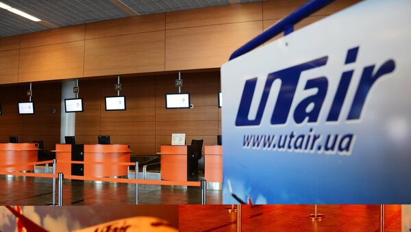 Логотип компании UTair в аэропорту. Архивное фото Логотип компании UTair в аэропорту. Архивное фото