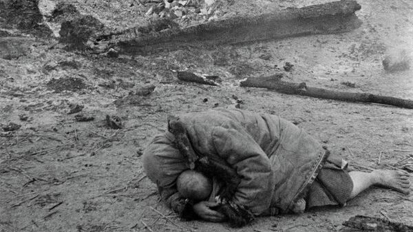 Мать укрывает своего ребенка во время обстрела. Деревня Красная слобода, Брянский фронт 1941 год Мать укрывает своего ребенка во время обстрела. Деревня Красная слобода, Брянский фронт 1941 год