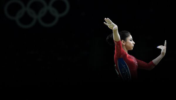 Седа Тутхалян (Россия) выполняет упражнения на бревне в командном многоборье среди женщин на соревнованиях по спортивной гимнастике на XXXI летних Олимпийских играх Седа Тутхалян (Россия) выполняет упражнения на бревне в командном многоборье среди женщин на соревнованиях по спортивной гимнастике на XXXI летних Олимпийских играх