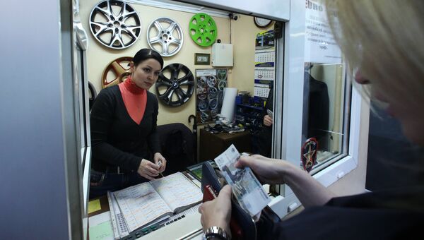 Автовладелец оплачивает услуги в кассе автосервиса Автовладелец оплачивает услуги в кассе автосервиса