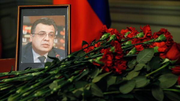 Цветы у портрета посла России в Турции Андрея Карлова. Архивное фото Цветы у портрета посла России в Турции Андрея Карлова. Архивное фото
