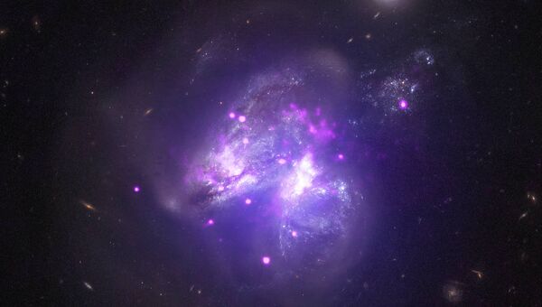 Сливающиеся галактики Arp 299 снятые телескопом Чандра Сливающиеся галактики Arp 299 снятые телескопом Чандра