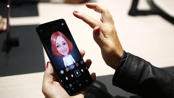 Девушка держит новый смартфон Samsung Galaxy S9 на мероприятии Samsung Galaxy Unpacked 2018 в Барселоне, Испания. 25 февраля 2018 года Девушка держит новый смартфон Samsung Galaxy S9 на мероприятии Samsung Galaxy Unpacked 2018 в Барселоне, Испания. 25 февраля 2018 года